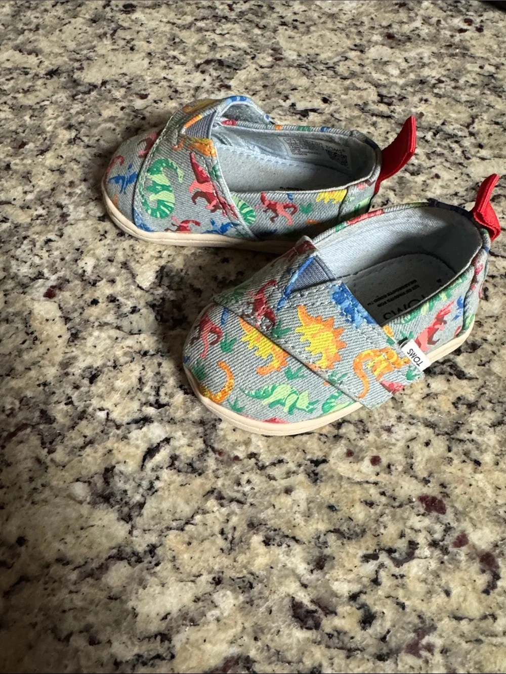 TOMS Baby Light Blue Slip-On Shoes with Multicolor Dino Print